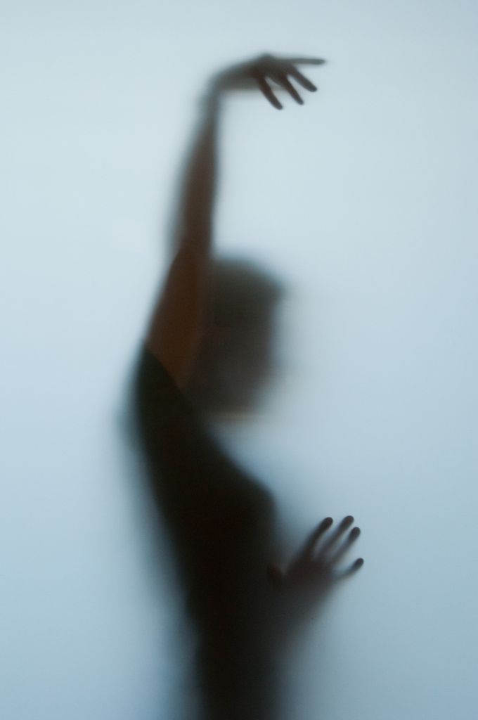 a blurry image of a person reaching up