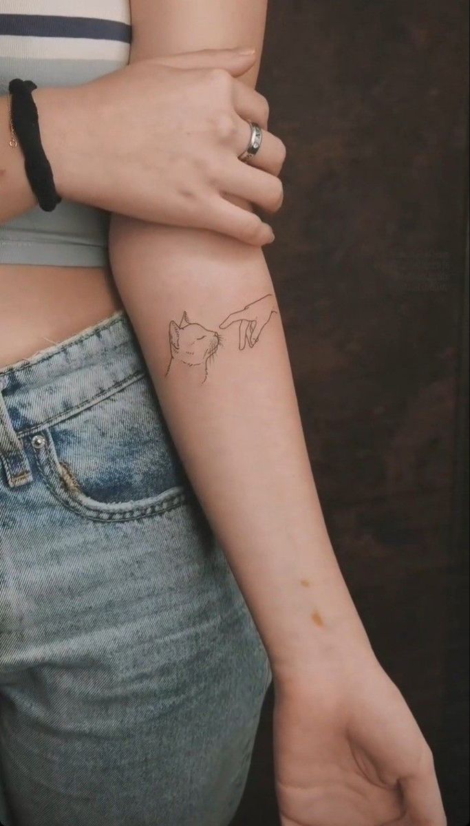 a woman with a small tattoo on her arm