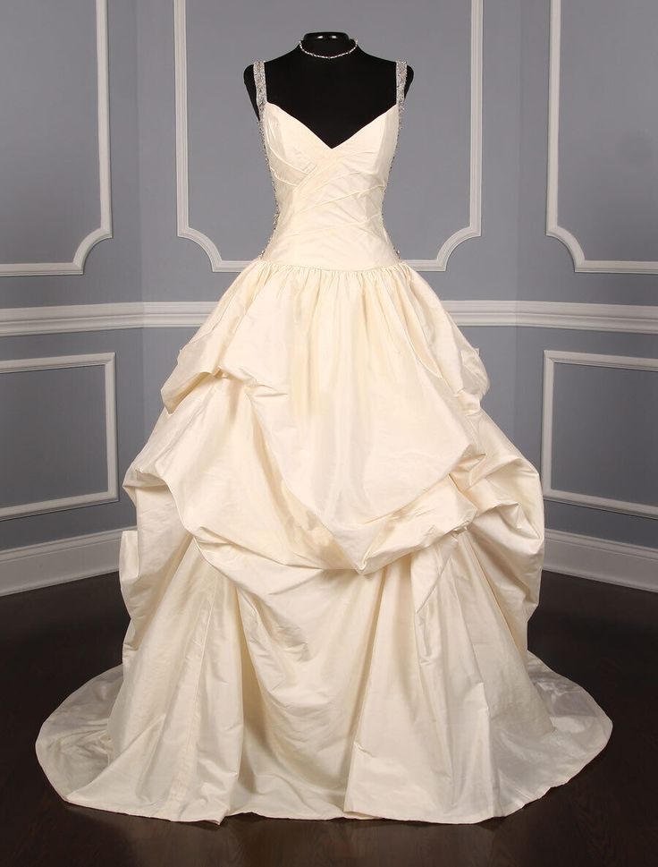 a white wedding dress on display in a room