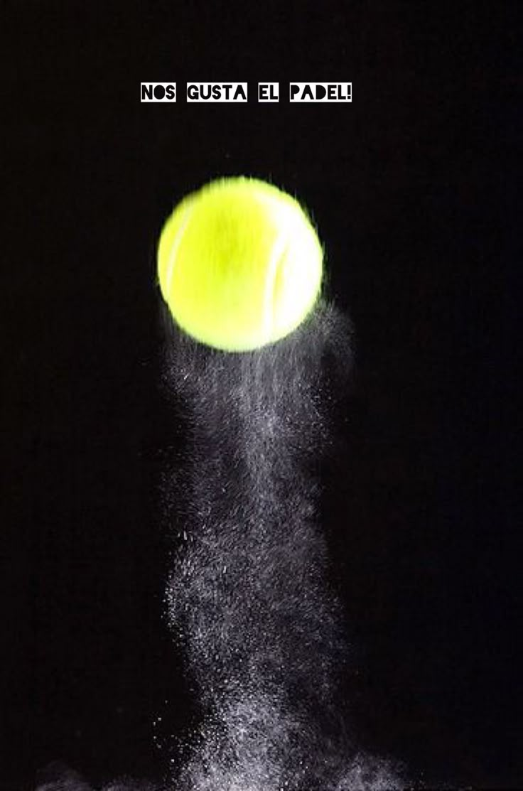 a tennis ball is hitting the net with it's sprinkles in the dark