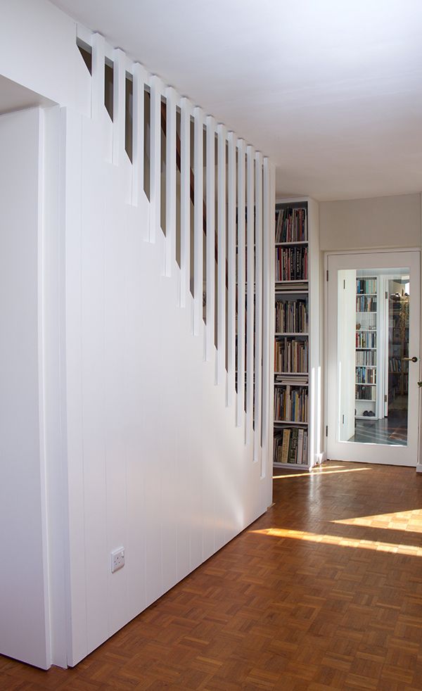 an empty room with bookshelves and hard wood flooring in front of the door