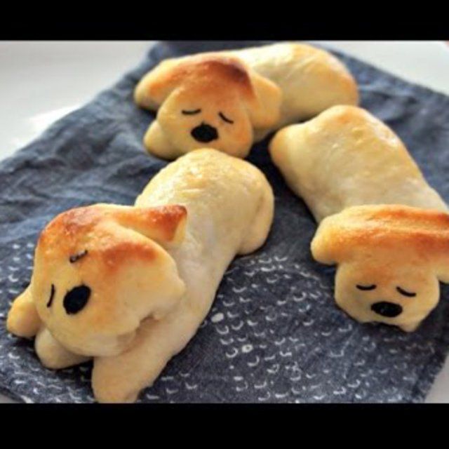 some bread shaped like dogs on a blue towel