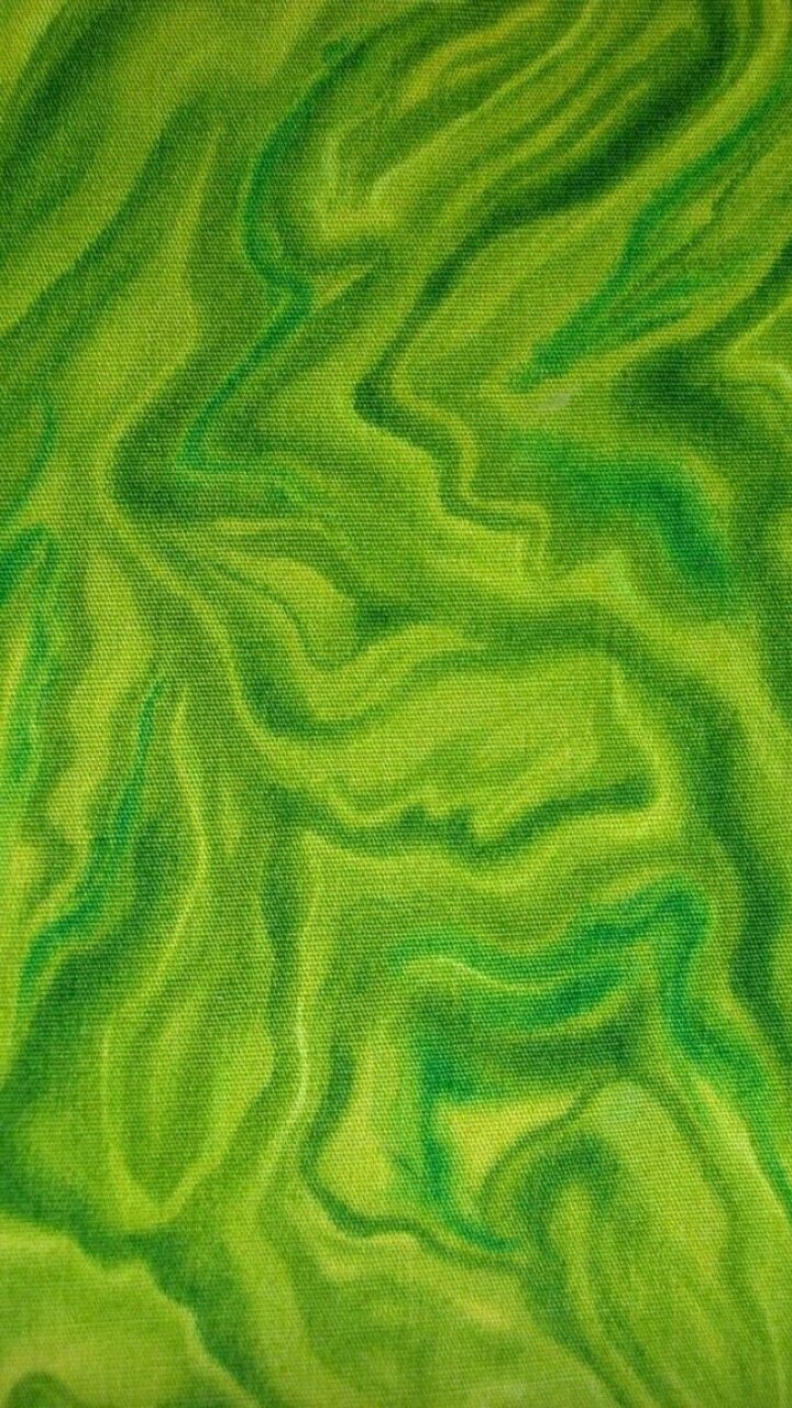 an image of green and black swirled fabric