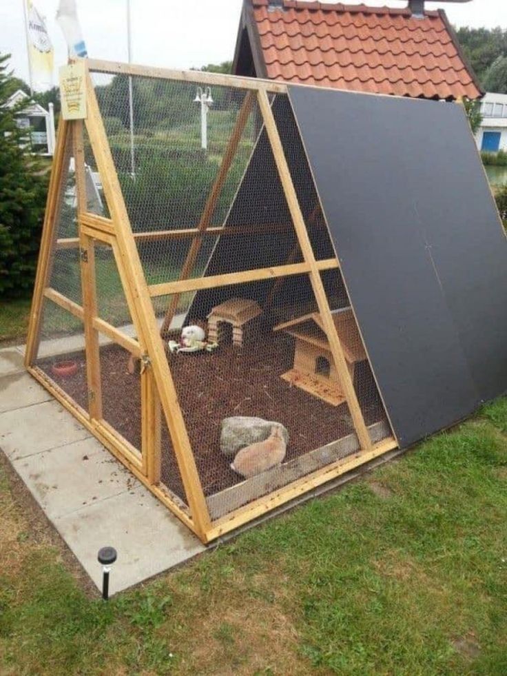 a chicken coop in the middle of a yard