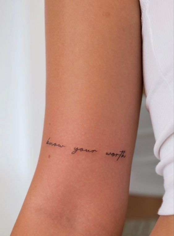 a woman with a tattoo on her arm that says, know your worth