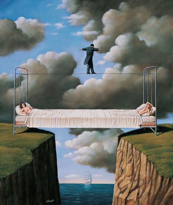 a man standing on top of a bridge over a body of water next to a cliff