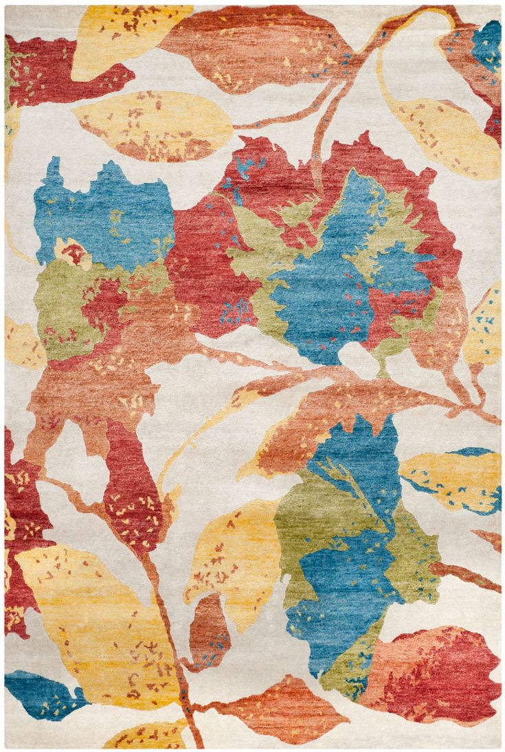 an area rug with colorful leaves on it