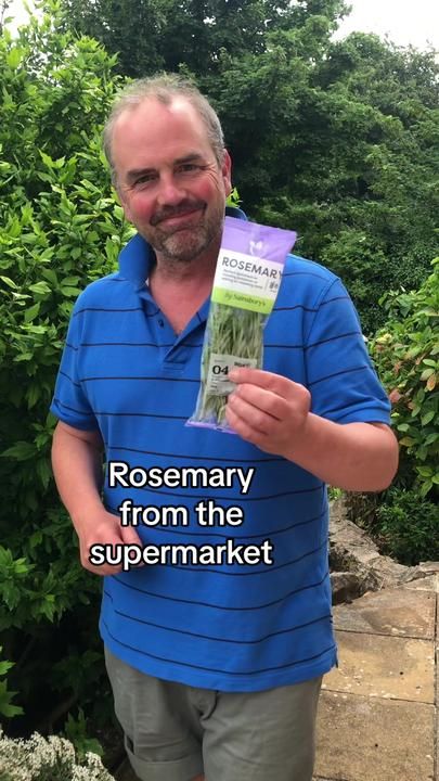 a man holding up a packet of rosemary from the supermarket