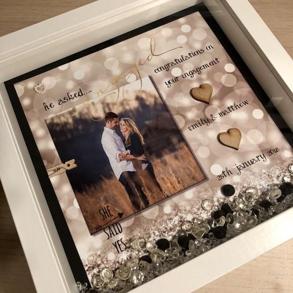 a photo frame with two hearts in it and some words written on the front, along with an image of a couple holding each other