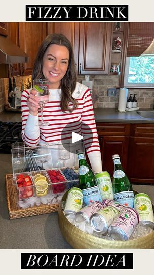 a woman standing in front of a counter filled with drinks