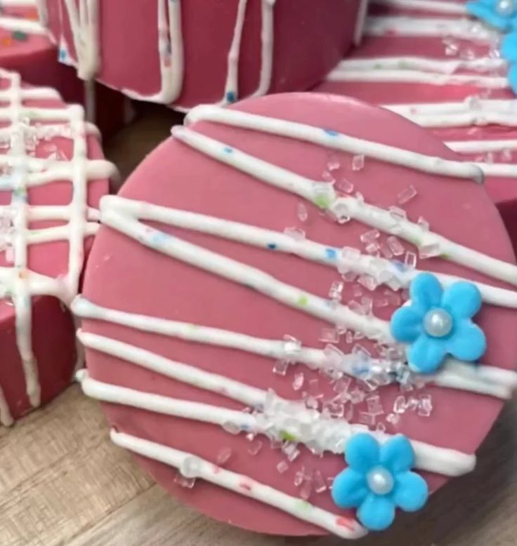 some pink and blue decorated cookies on a table