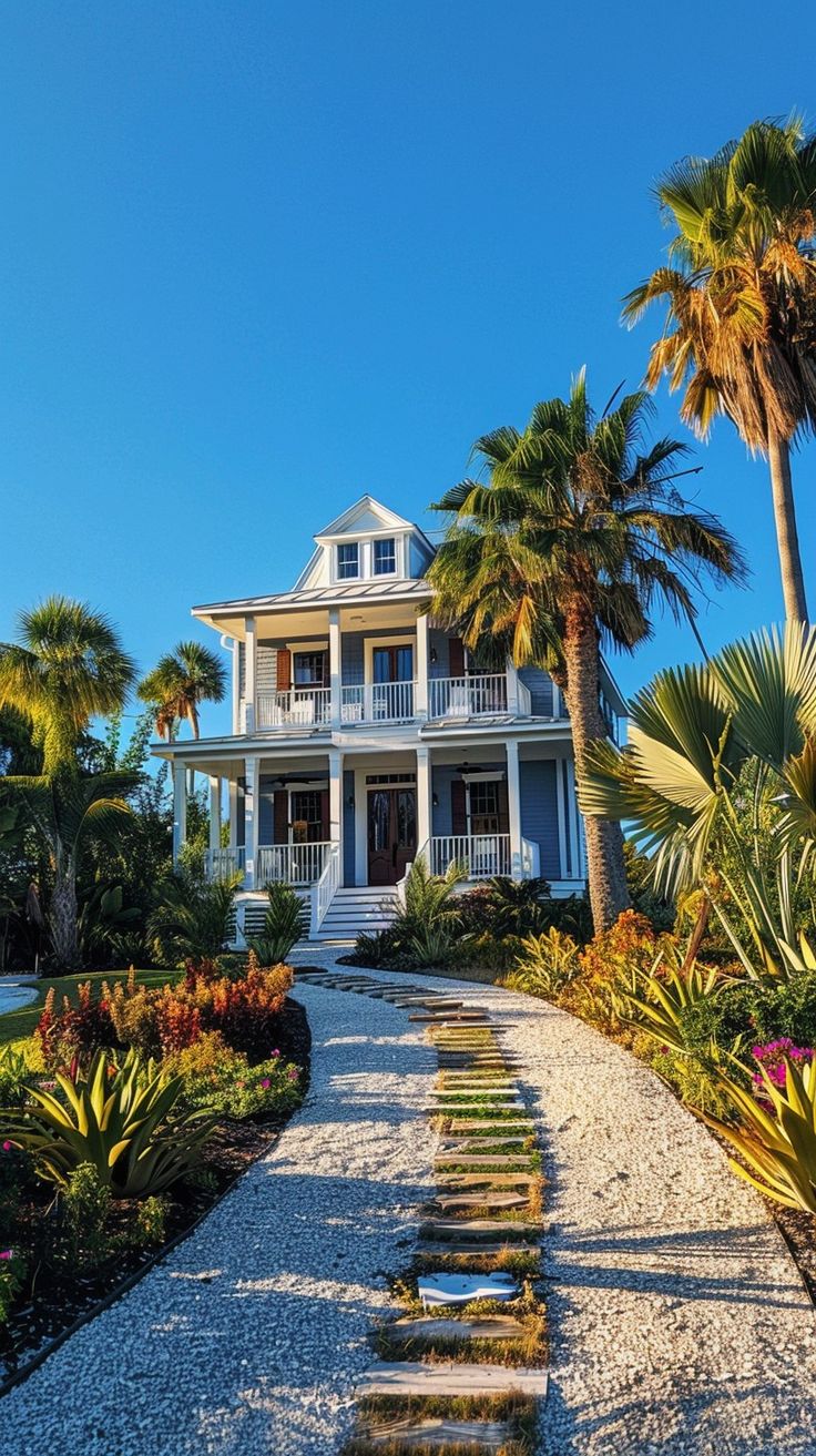 Serene blue beach house surrounded by lush tropical garden with vibrant plants, luxury vacation home concept Malibu House Beach, House Dubai, Blue Beach House, Garden Luxury, Ariel Wedding, Tropical Beach Houses, Malibu House, Modern Coastal Home, Dream Beach House