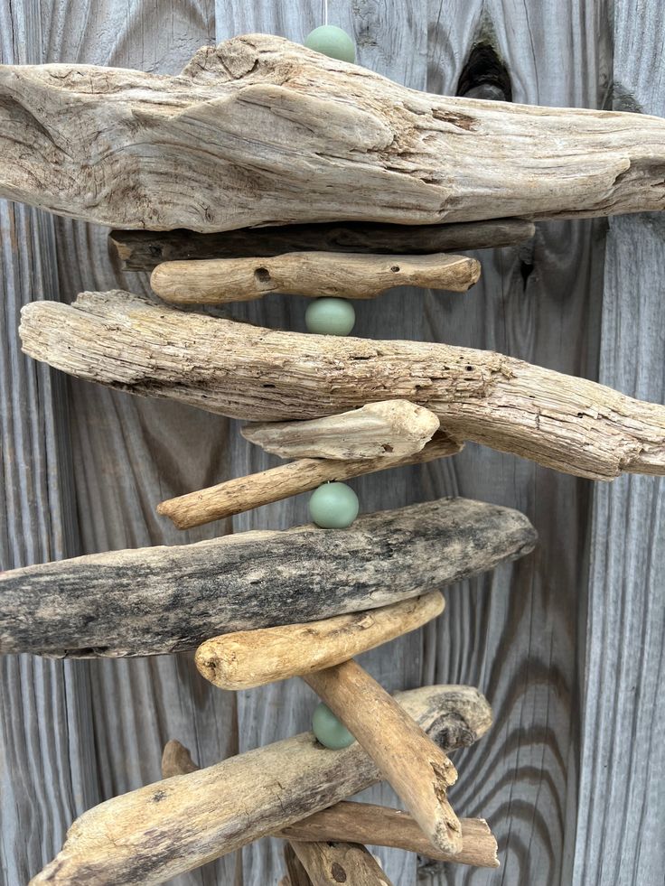 driftwood with green beads hanging from it