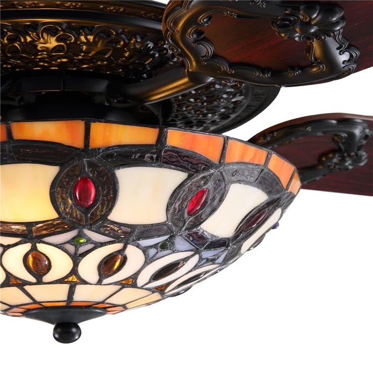 a close up of a ceiling light with stained glass shades on the top and bottom