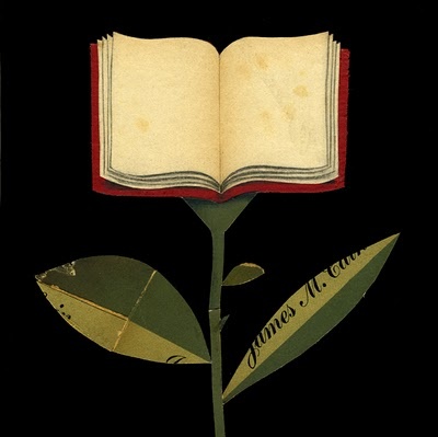 an open book sitting on top of a flower