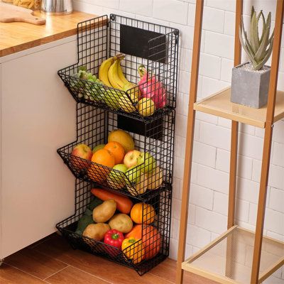 three baskets filled with fruit sitting on top of a counter next to a wooden shelf