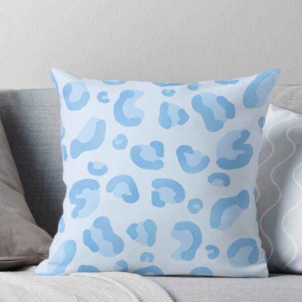 a blue leopard print pillow sitting on top of a couch