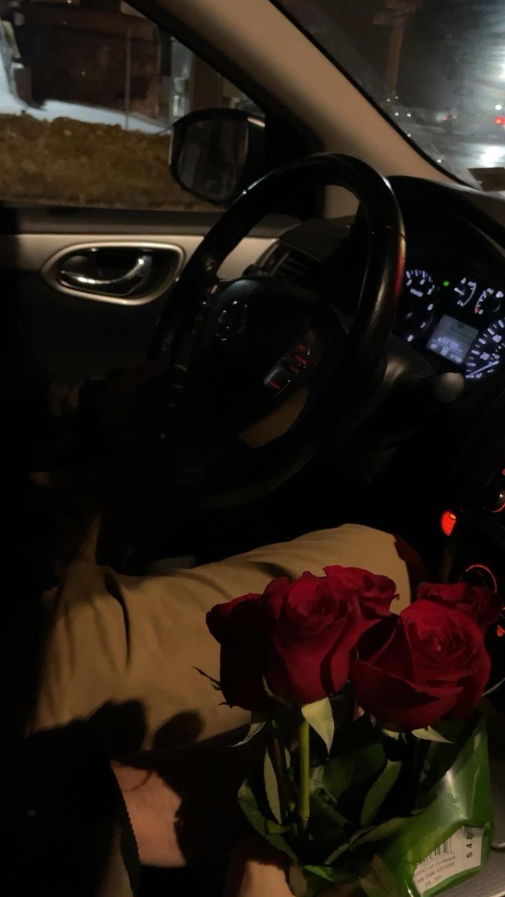 a bunch of roses sitting in the passenger seat of a car