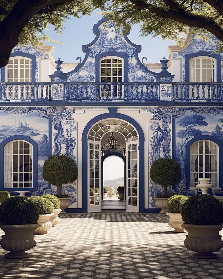 an ornate blue and white building with potted plants