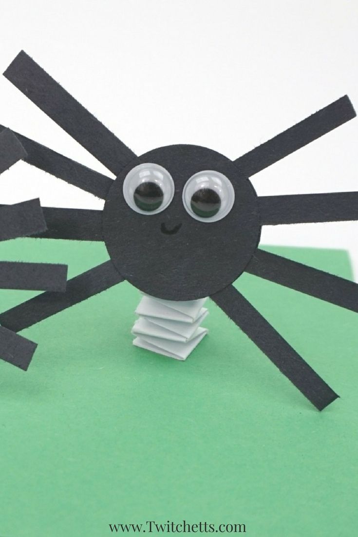 a spider made out of toilet paper on top of a green surface