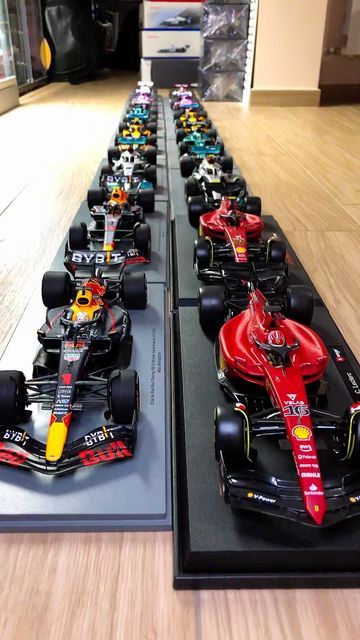 several model cars lined up on display in a store