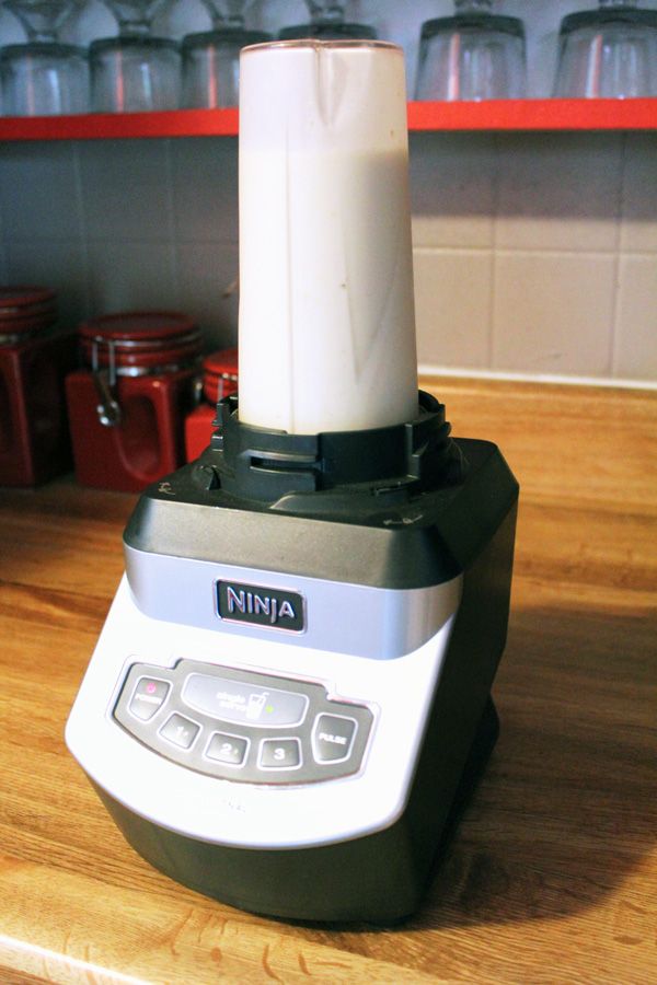 a blender sitting on top of a wooden counter