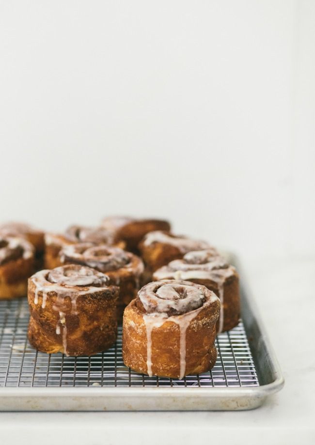 cinnamon rolls with icing on a cooling rack