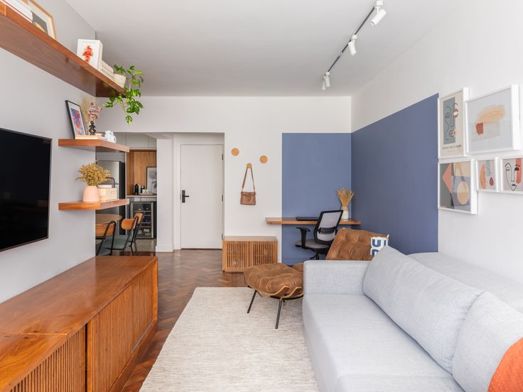 a living room filled with furniture and a flat screen tv