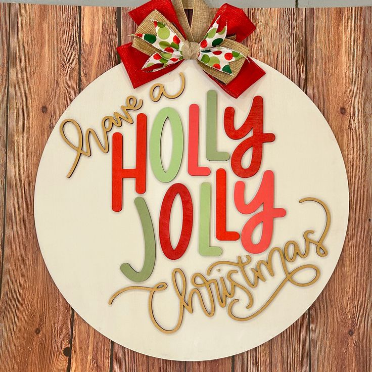 a christmas ornament hanging on the side of a wooden wall that says we are holly jolly christmas