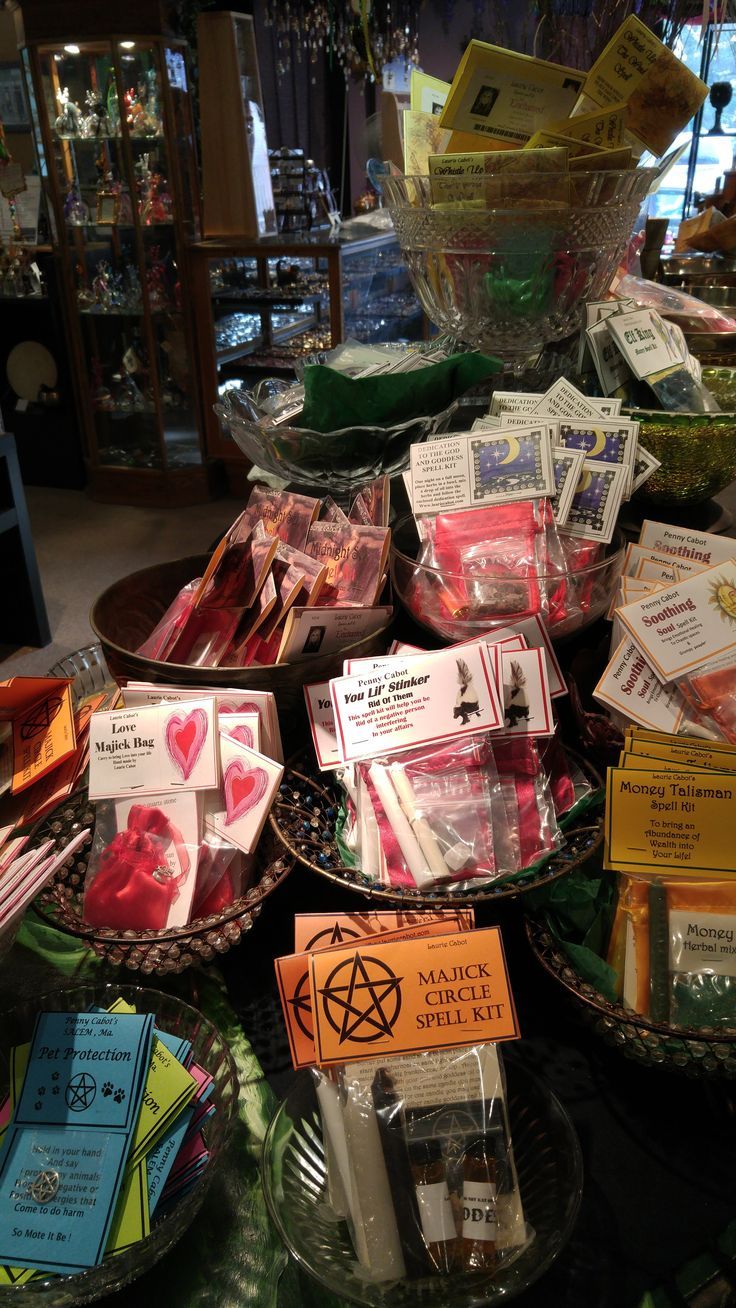 there are many items on the table for sale in this store, including candy bars and cards