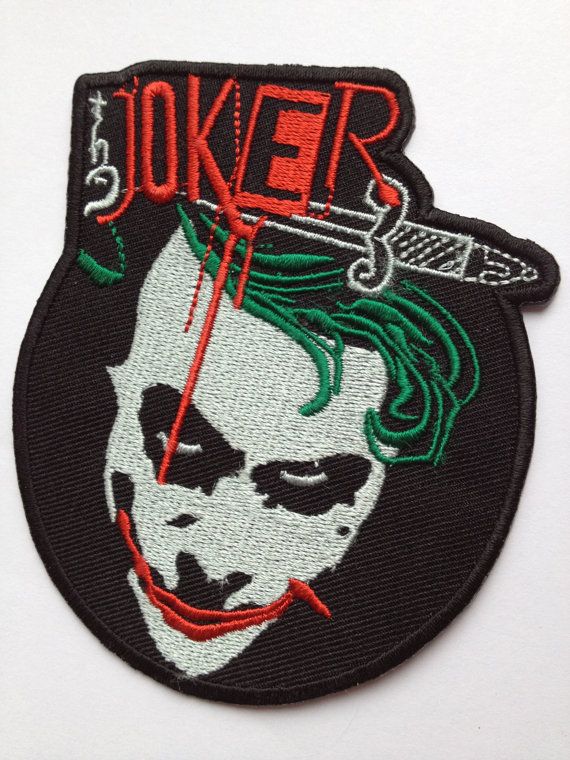 a patch with the face of joker on it's back and words that say,