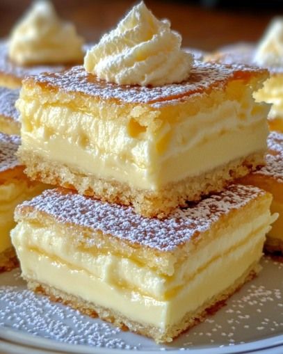 four pieces of cake sitting on top of a plate covered in powdered sugar and icing