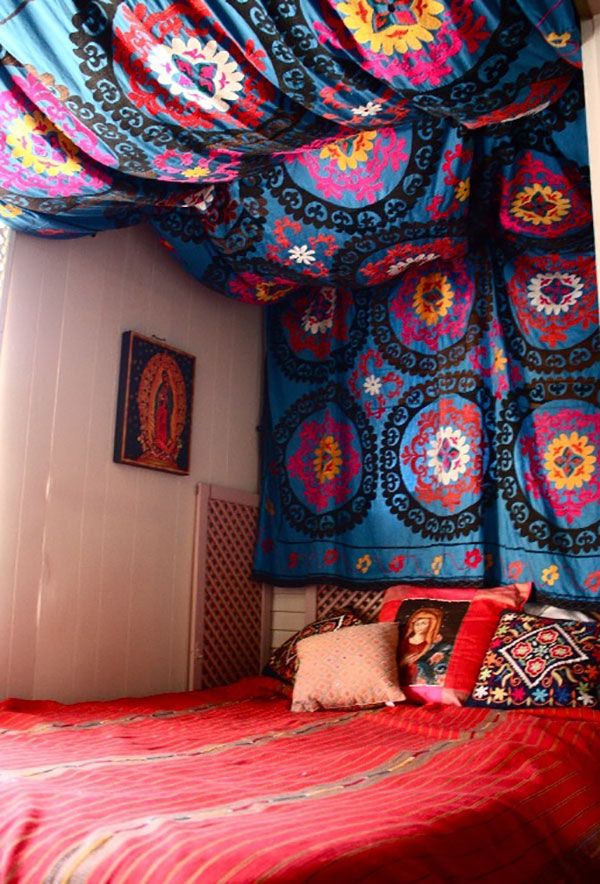 a bed with colorful bedspread and pillows on it