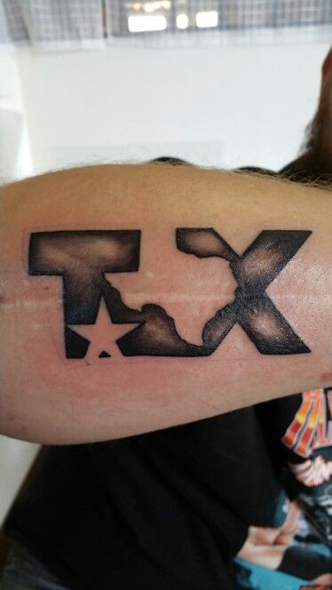 a man's arm with the letter x on it