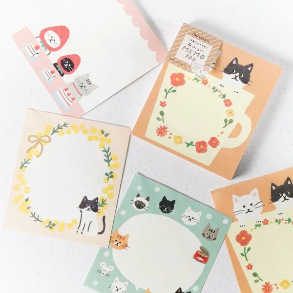 four cards with cats and flowers on them, one has a blank space in the middle