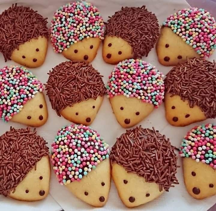 hedgehog cookies decorated with sprinkles on a plate