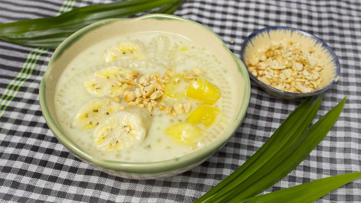 a bowl filled with oatmeal and some green leaves