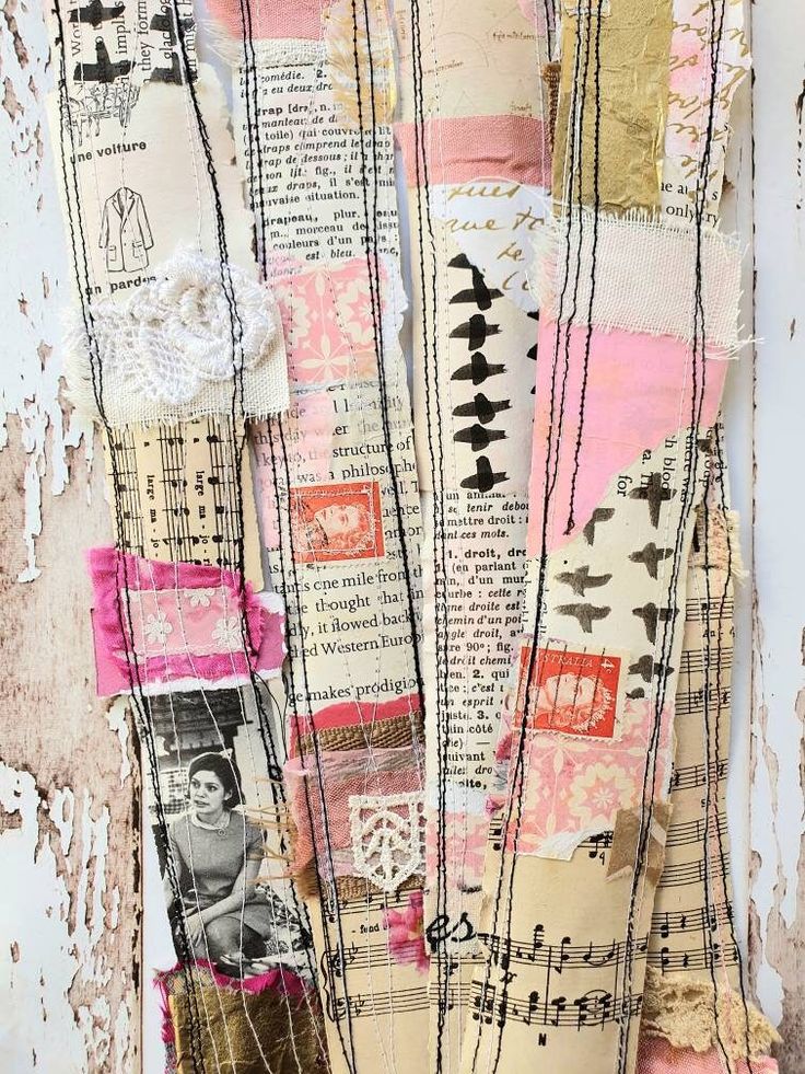 an altered collage of old papers and other items on a wall with peeling paint