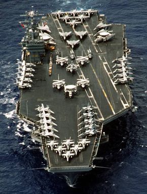 an aircraft carrier in the middle of the ocean