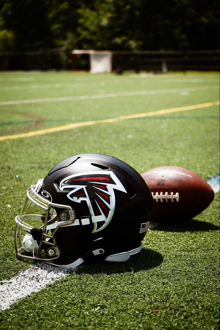 a football helmet sitting on top of a field