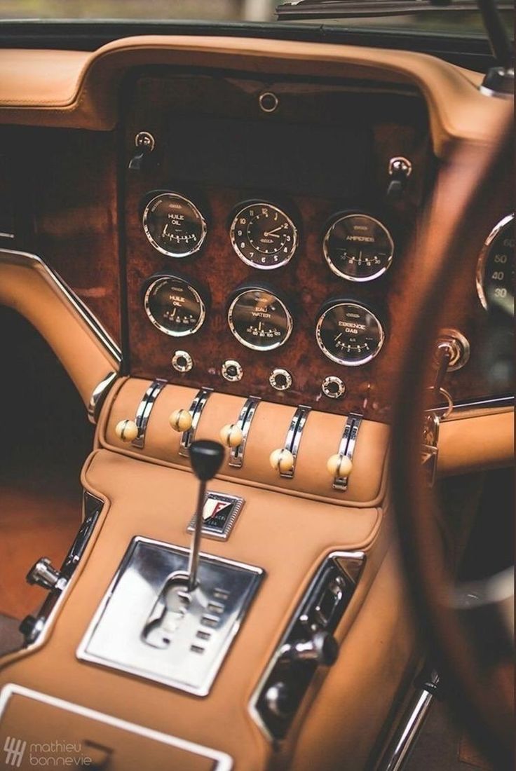 the interior of an old car with gauges and dash boards