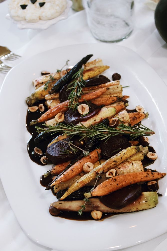 a white plate topped with carrots and other vegetables