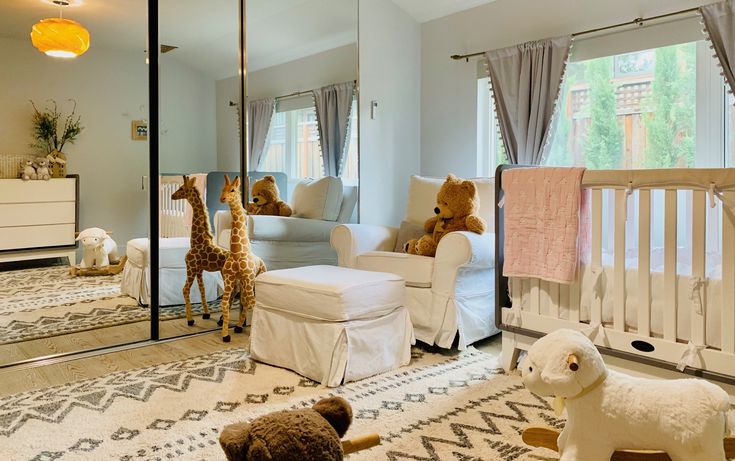 a baby's room with stuffed animals in the crib and mirrors on the wall