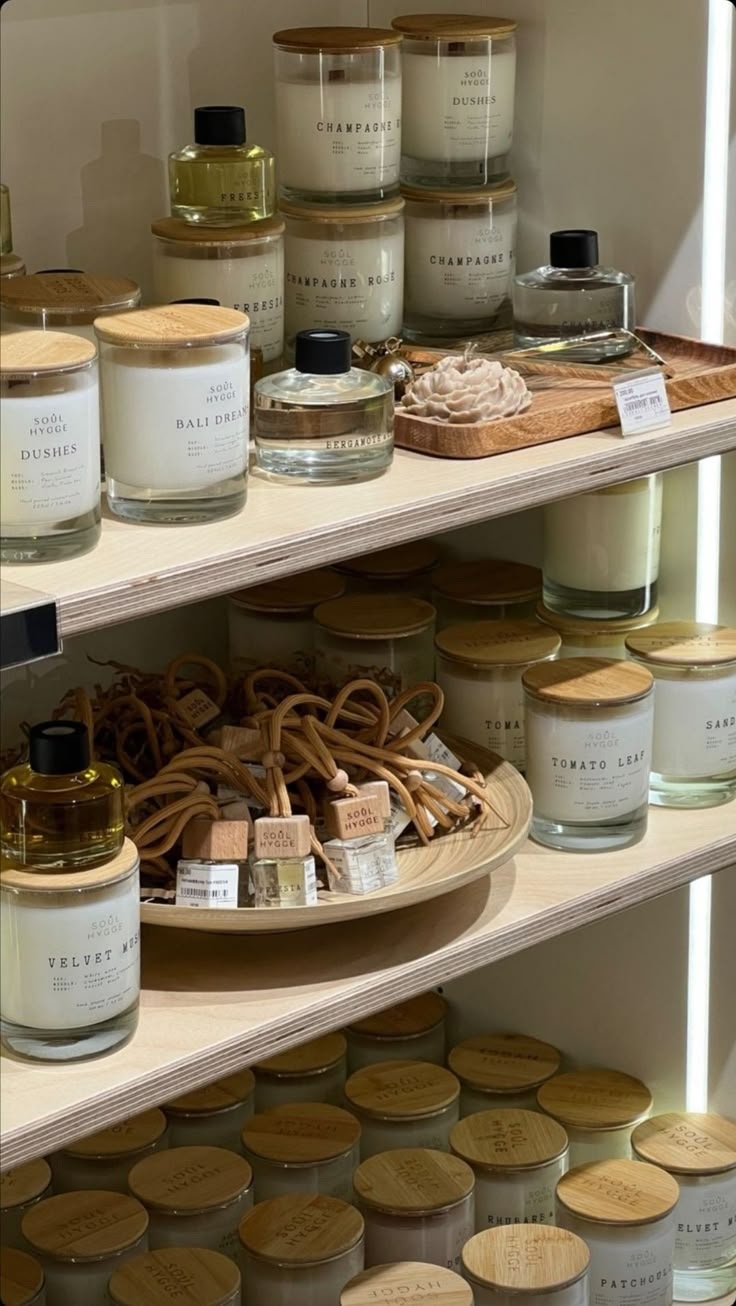 shelves filled with jars and candles on top of each other