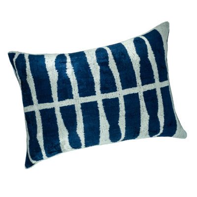 a blue and white pillow on a white background