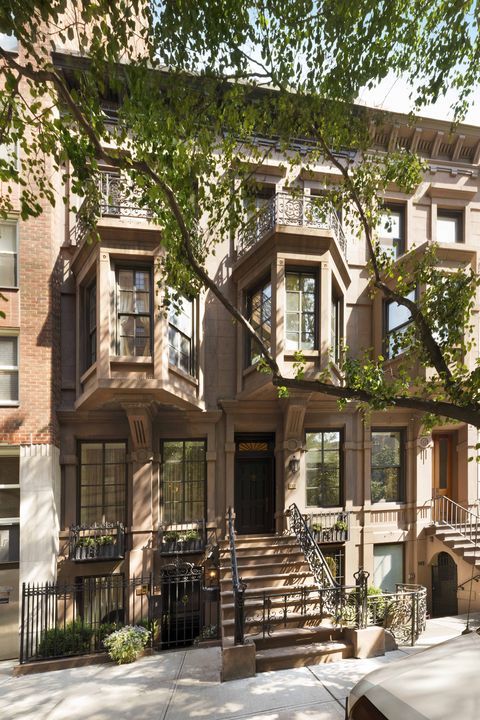 an apartment building with stairs leading up to it