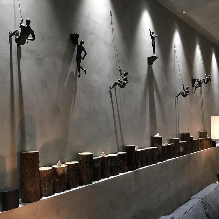 a room with sculptures on the wall and lamps