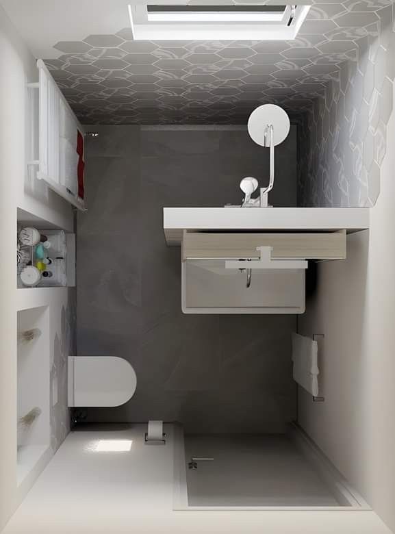 a small bathroom with a toilet, sink and mirror in it's stall area