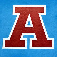 the letter a is painted red and white on a blue background