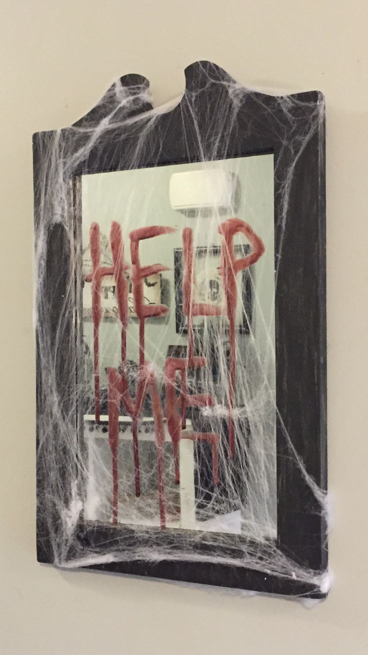 there is a sign on the wall that says help from it's spider web